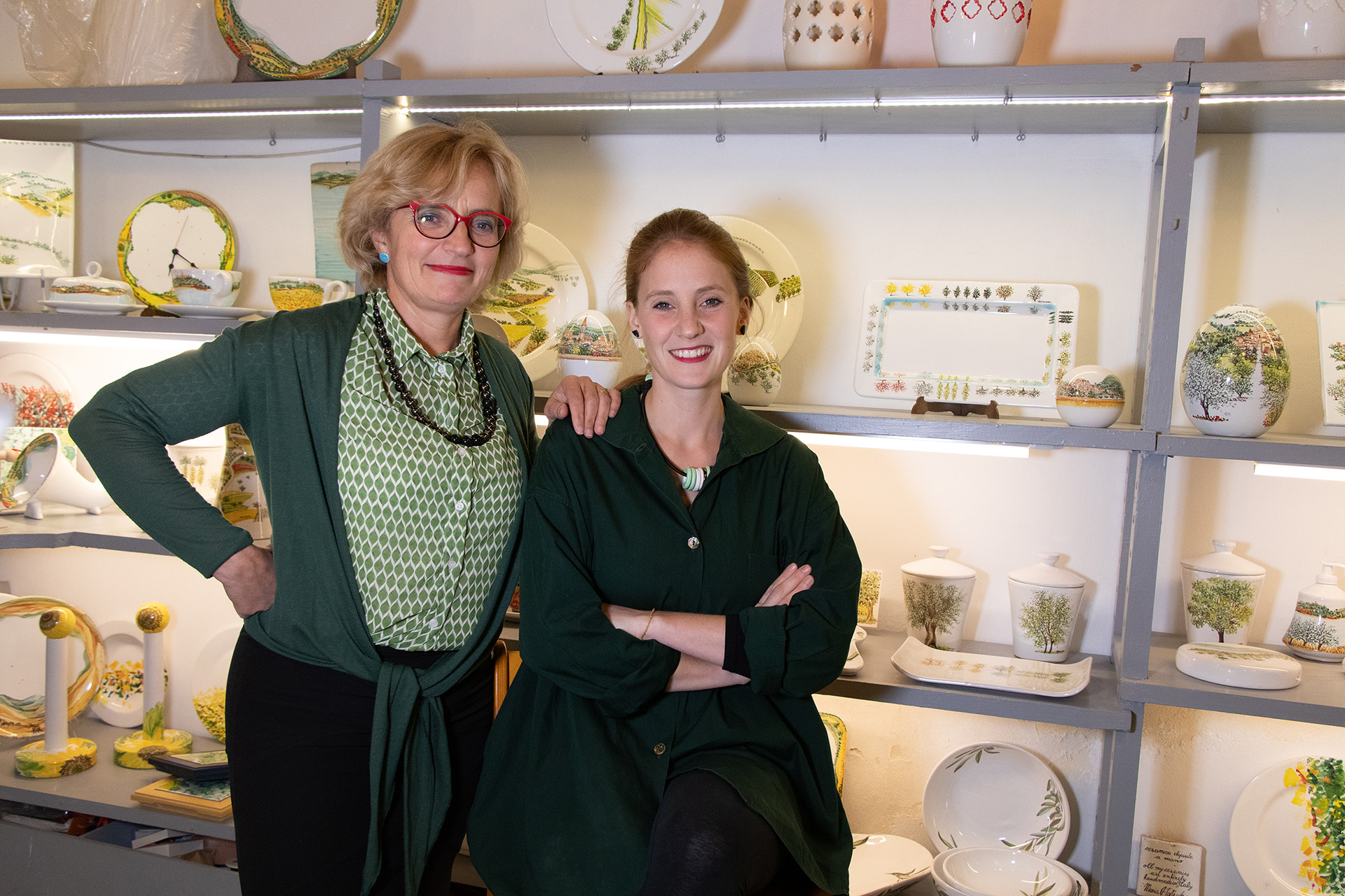 Ceramic artists Maria Antonietta Tattichi and Caterina Aquinardi in their shop in Perugia, Italy with their ceramics on display